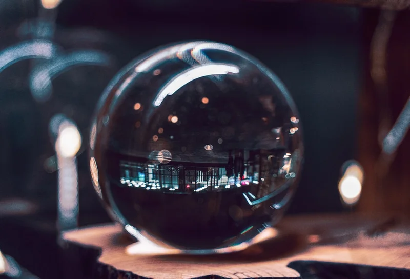 City lights reflected in a glass orb